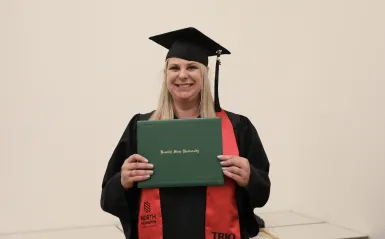 Melissa Sawyer with her BSU diploma at graduation 
