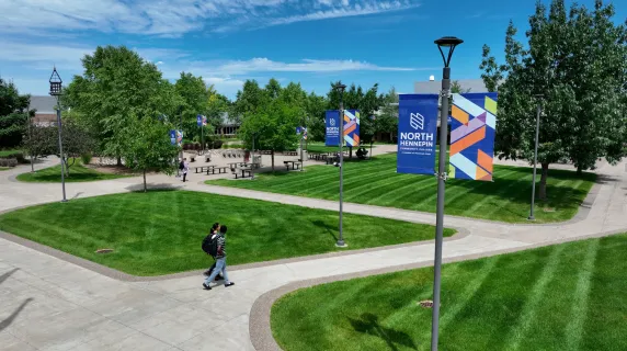 drone shot of students walking on campus on a sunny day