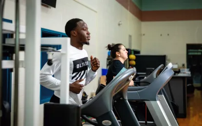 students running on the treadmills in the gym