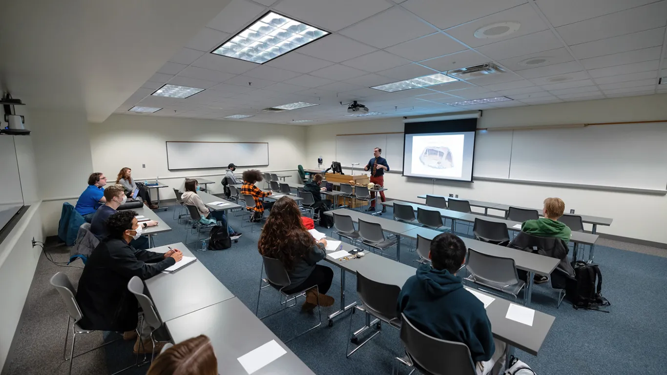 a wide shot of students sitting in a classroom 