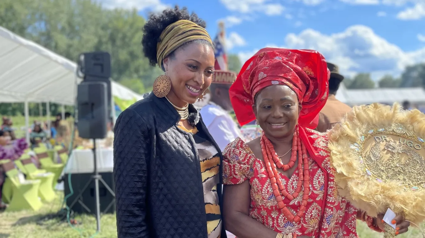 two women smiling at an event 