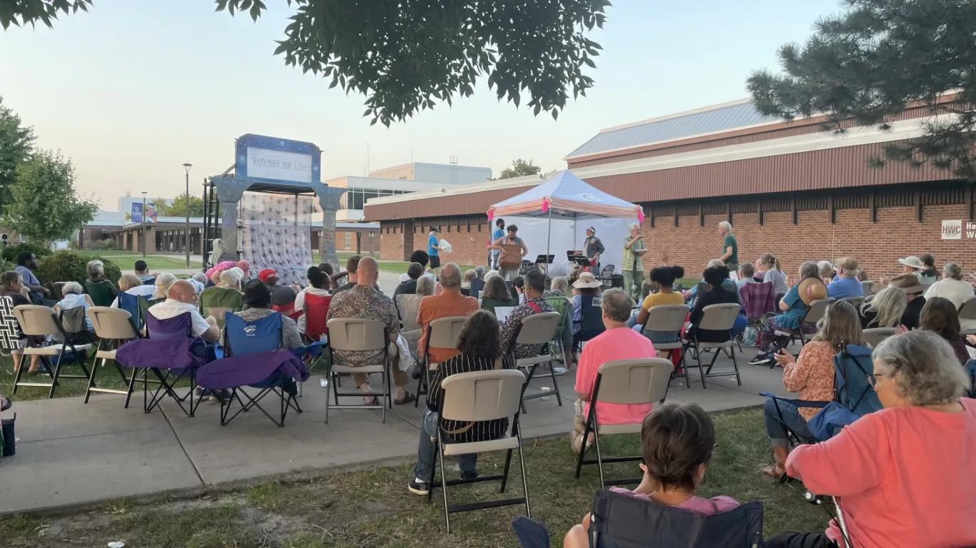 people sitting in chairs at a campus event 