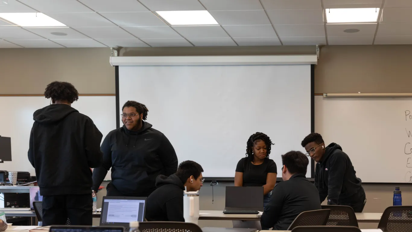 students working and talking in a classroom 