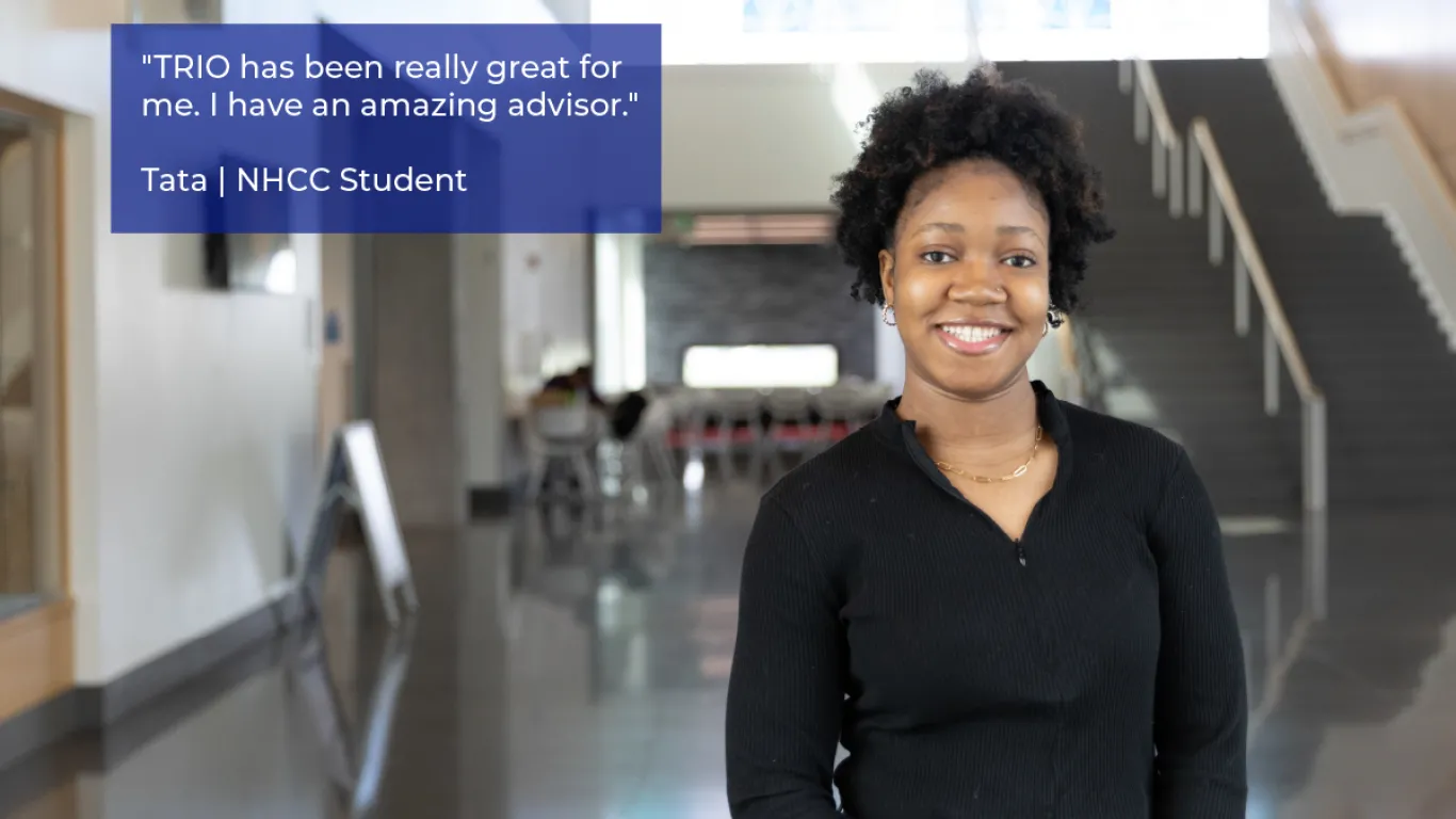 student smiling in a hallway