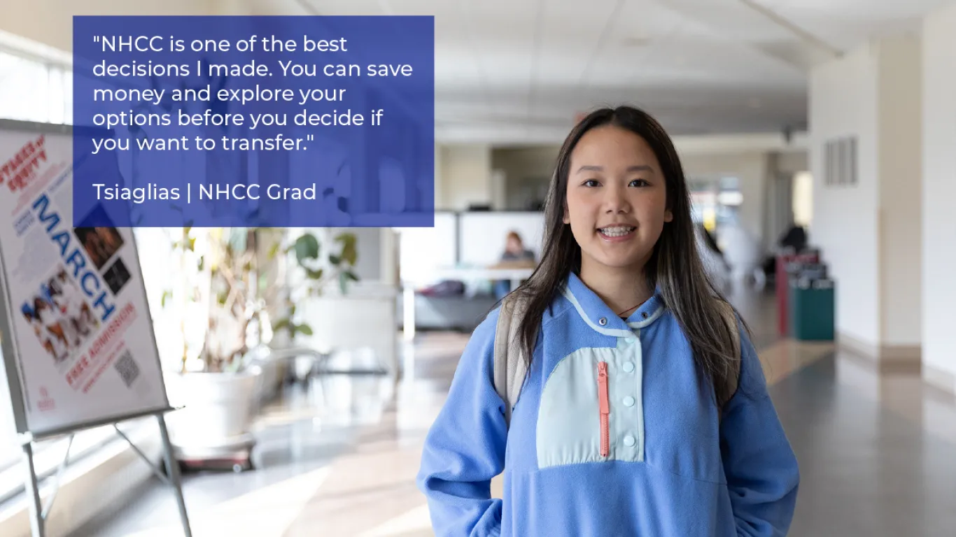 student smiling wearing a backpack in a hallway