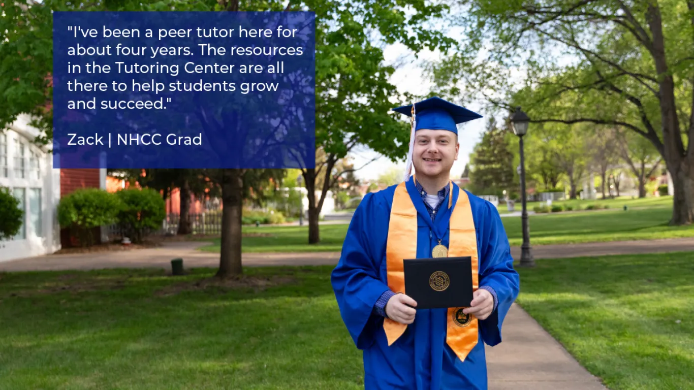 graduate smiling holding a diploma wearing a cap and gown