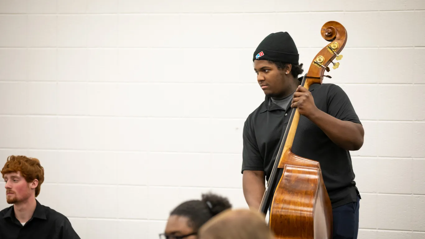 student playing upright bass in class