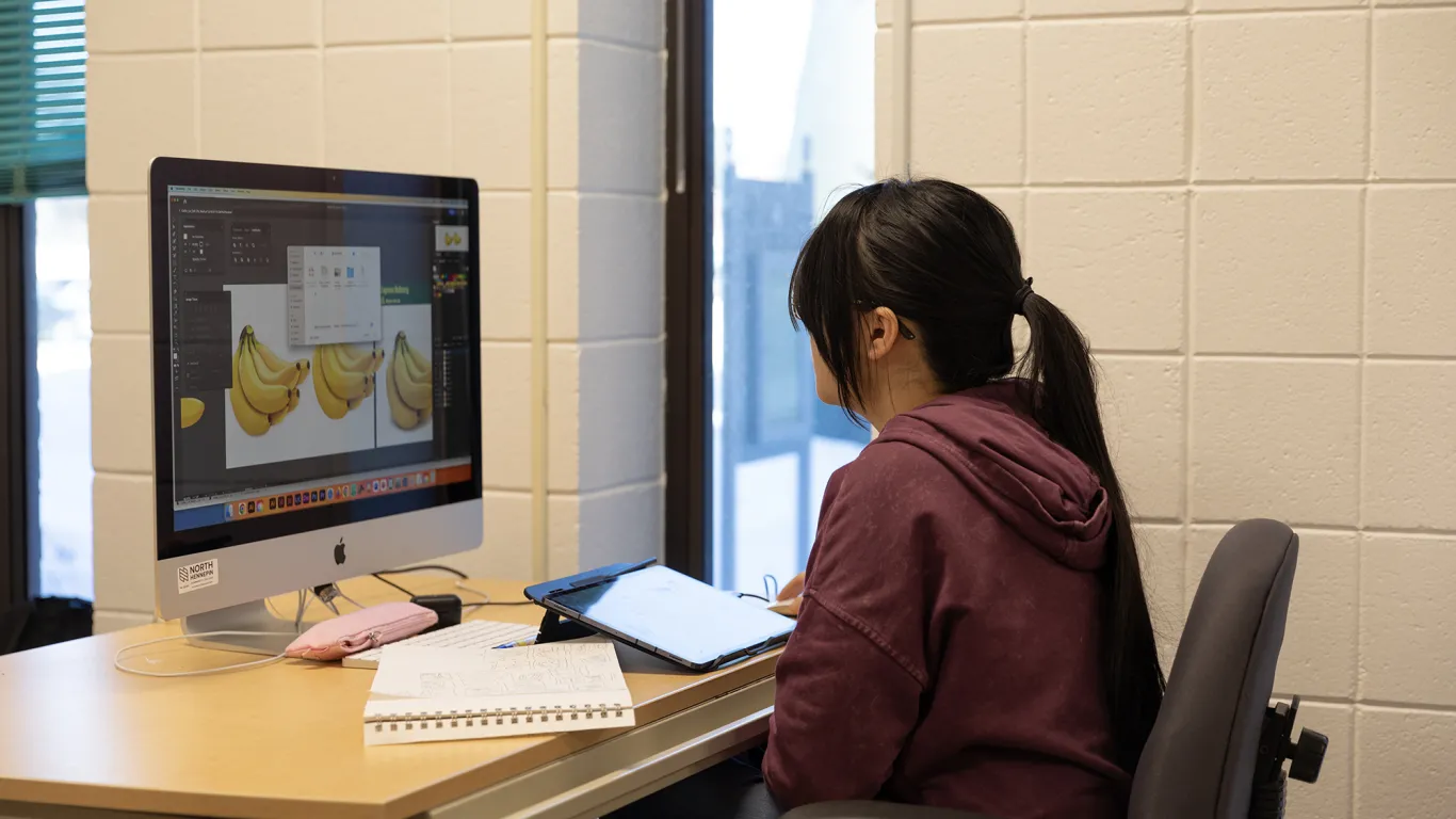 a student working on a design at a computer