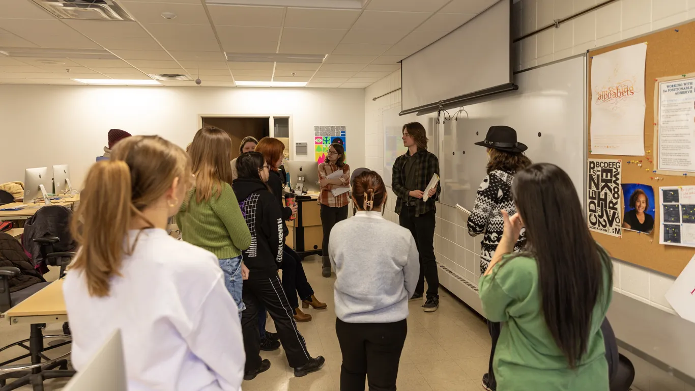 a student showing their work to a group of students 