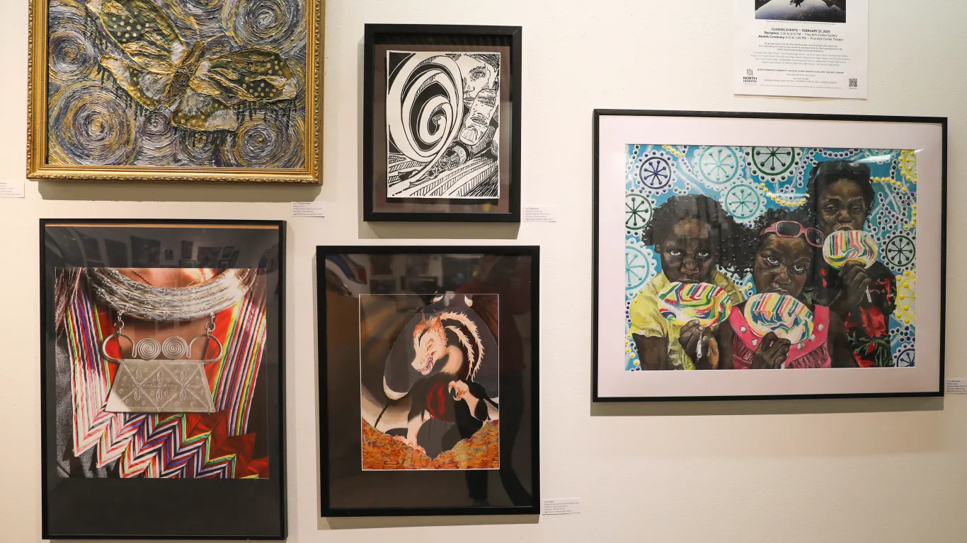 A group of artwork from the 2025 High School Art Show Exhibit. This display includes acrylic paintings, a printmaking piece, a photograph and 3D paintings. 