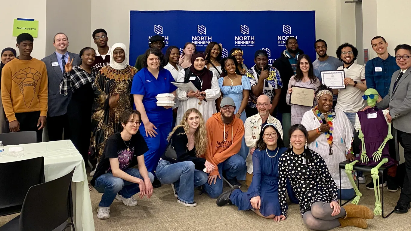 This is a group photo of various students and staff who attended the Student Life Awards Banquet. The group piled together for a photo in front of the NHCC logo backdrop.