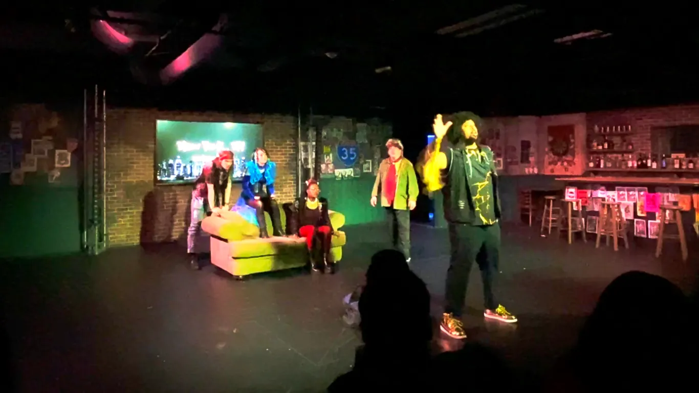 Actors performing on stage in the play “Airness”