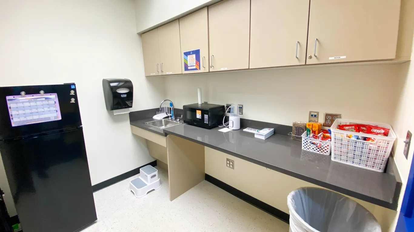 kitchen shelf with a faucet and a refrigerator