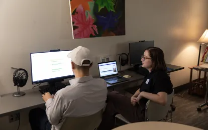 two people working at a computer 