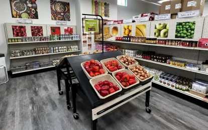 shelves with food and baskets of red peppers 