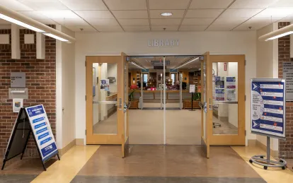 large doors with the a sign that says library above the doors 