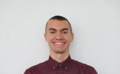 man smiling wearing red top