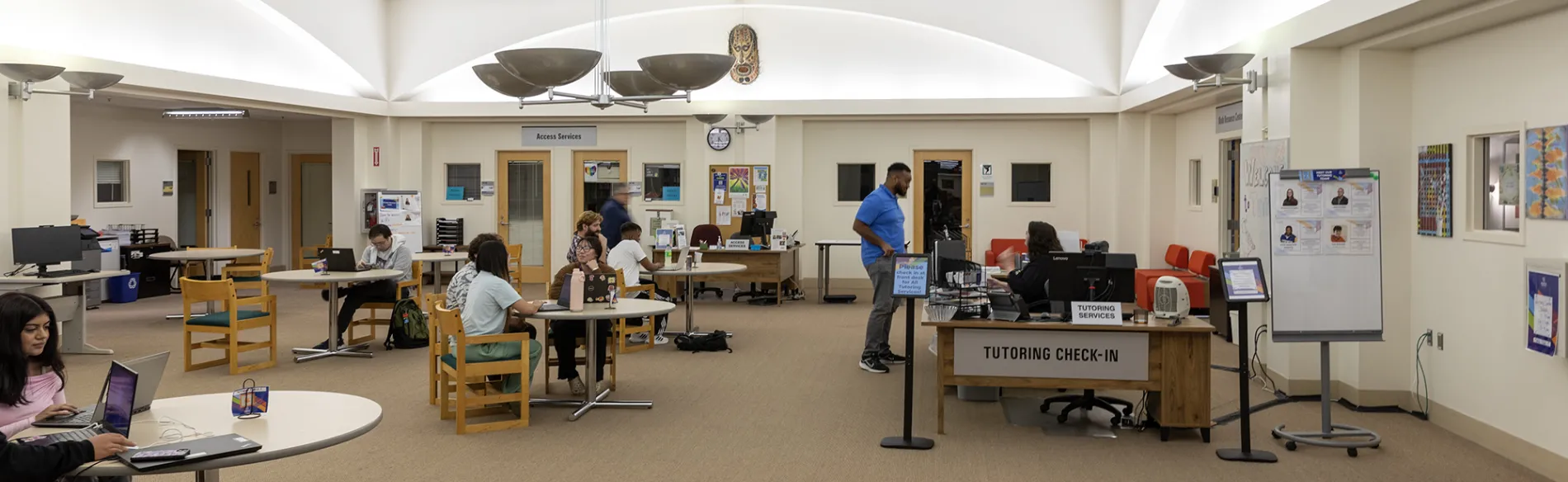 students working with tutors at desks