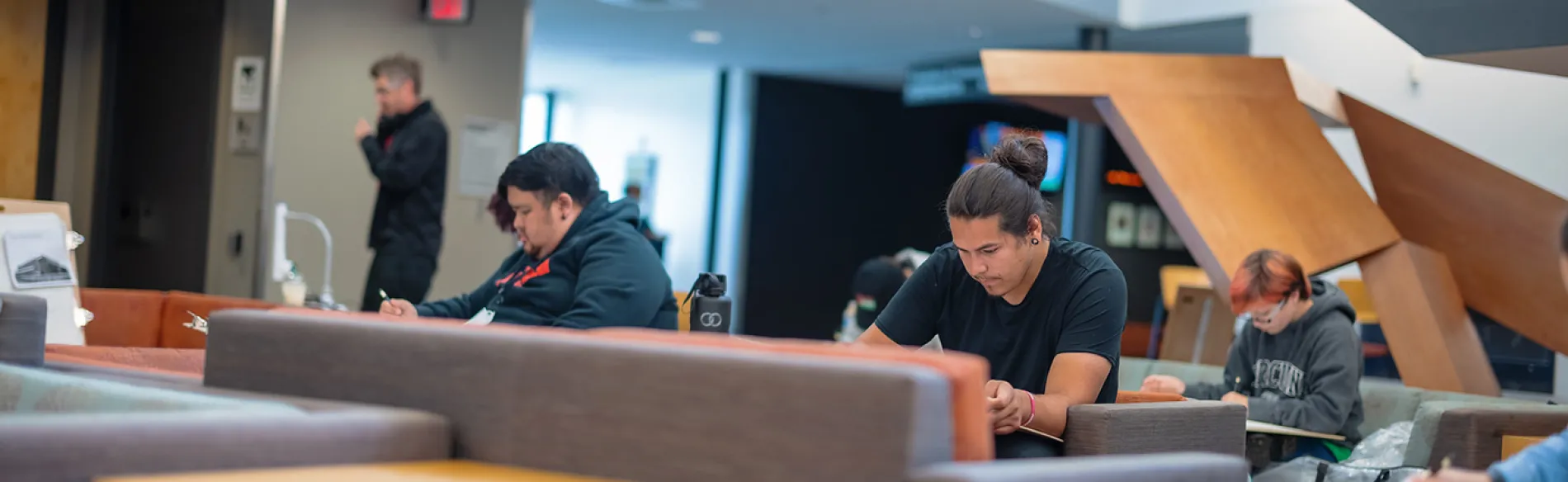 students working on a project in a lounge area