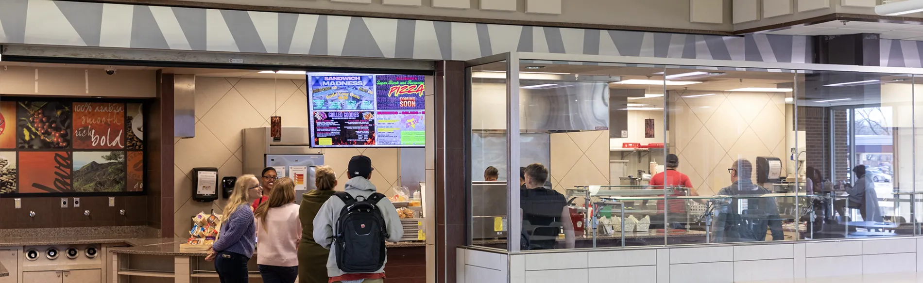 students standing near a restaurant counter