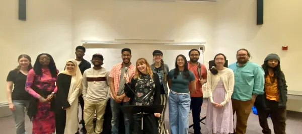 Group of students standing in classroom smiling