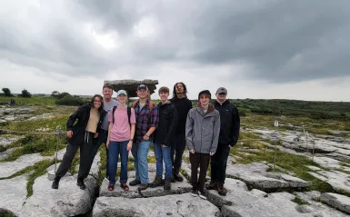 a photo of NHCC faculty, Paul Melchior and several NHCC students smiling in a group photo together in Ireland, while studying abroad