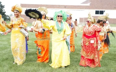 this is a photo of African women dressed in their cultural regalia, outside on the NHCC campus grass during their IgboFest Celebration event.