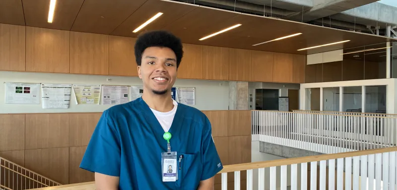 student smiling near a staircase