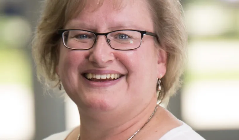 Paralegal Program Director & Instructor, Mary Fenske standing outside smiling at the camera