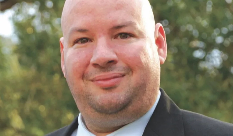 NHCC president Rolando Garcia standing outside smiling at the camera