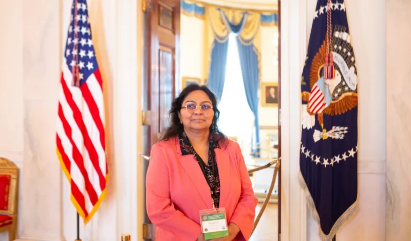 Dr. Eugenia Paulus standing inside white house