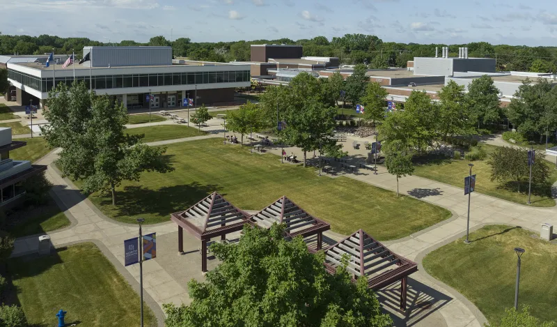 arial view of campus courtyard with trees buildings and a few students