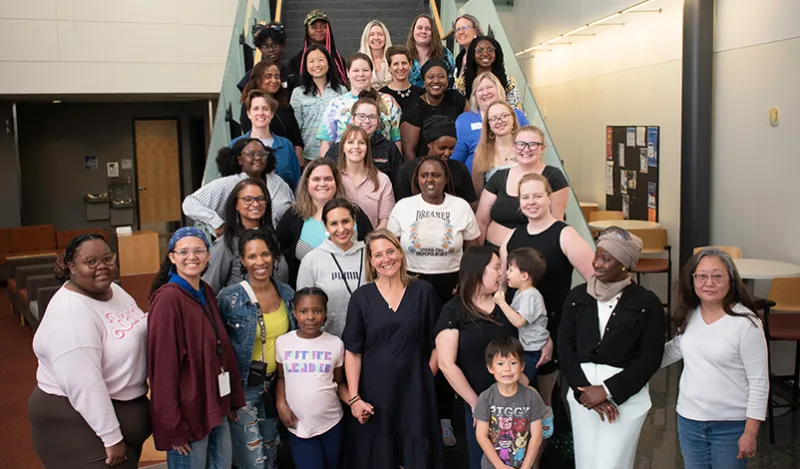 groups of smiling students and mentors on staircase