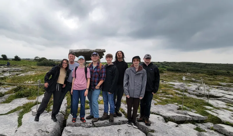 a photo of NHCC faculty, Paul Melchior and several NHCC students smiling in a group photo together in Ireland, while studying abroad