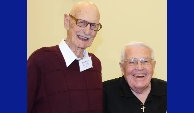 this is a photo of two legendary men in NHCC's history. Smiling next to each other are, former and longest serving NHCC President, Dr. John Helling on the left, next to Eldon Tessman, devoted community member and NHCC Foundation establisher in 2019 at an on-campus event. This is one of the final photos taken of them together.