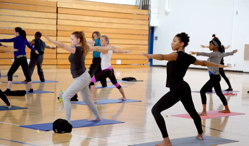 exercise science students doing yoga in a gym