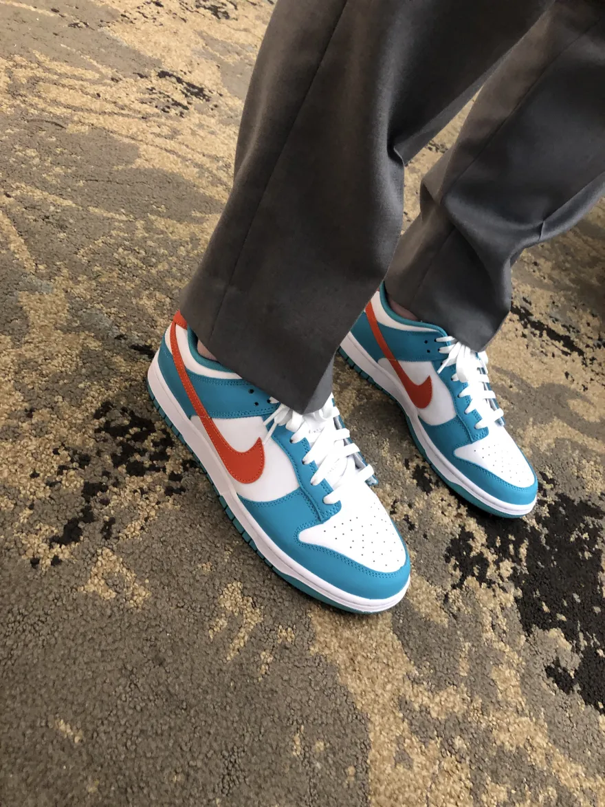 A photo of a blue and orange pair of Nike sneakers