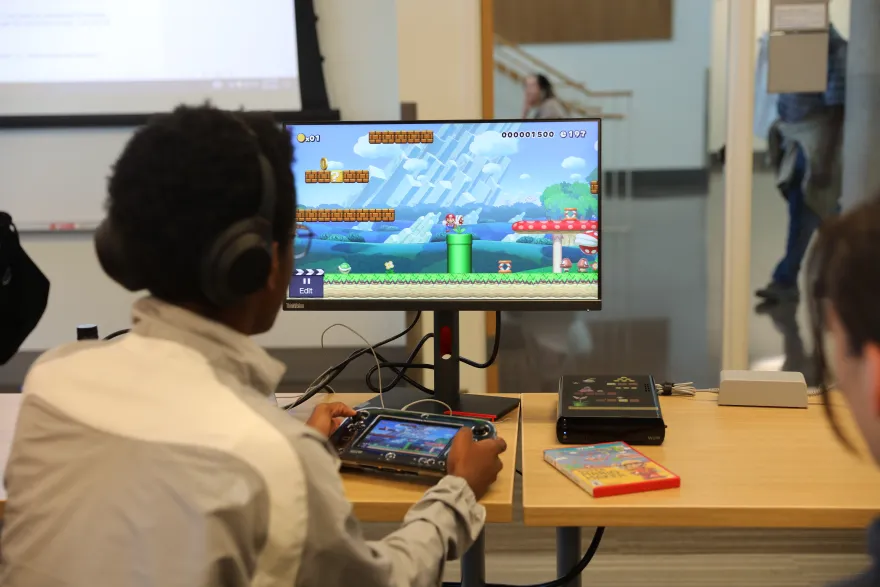 a photo of a student playing video games