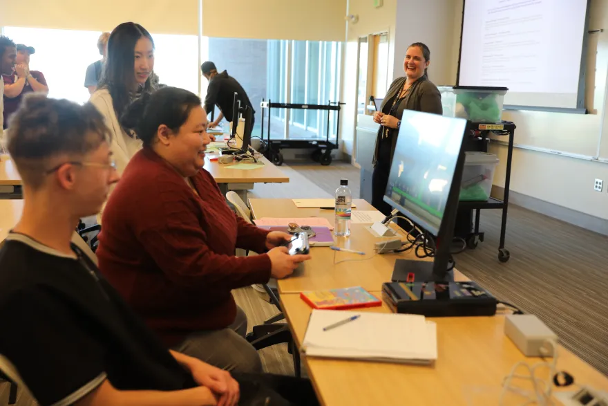 a photo of three students playing video games