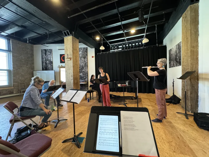 a photo of Gary Ruschman's easel in the songwriting process, in a room with other musicians. 