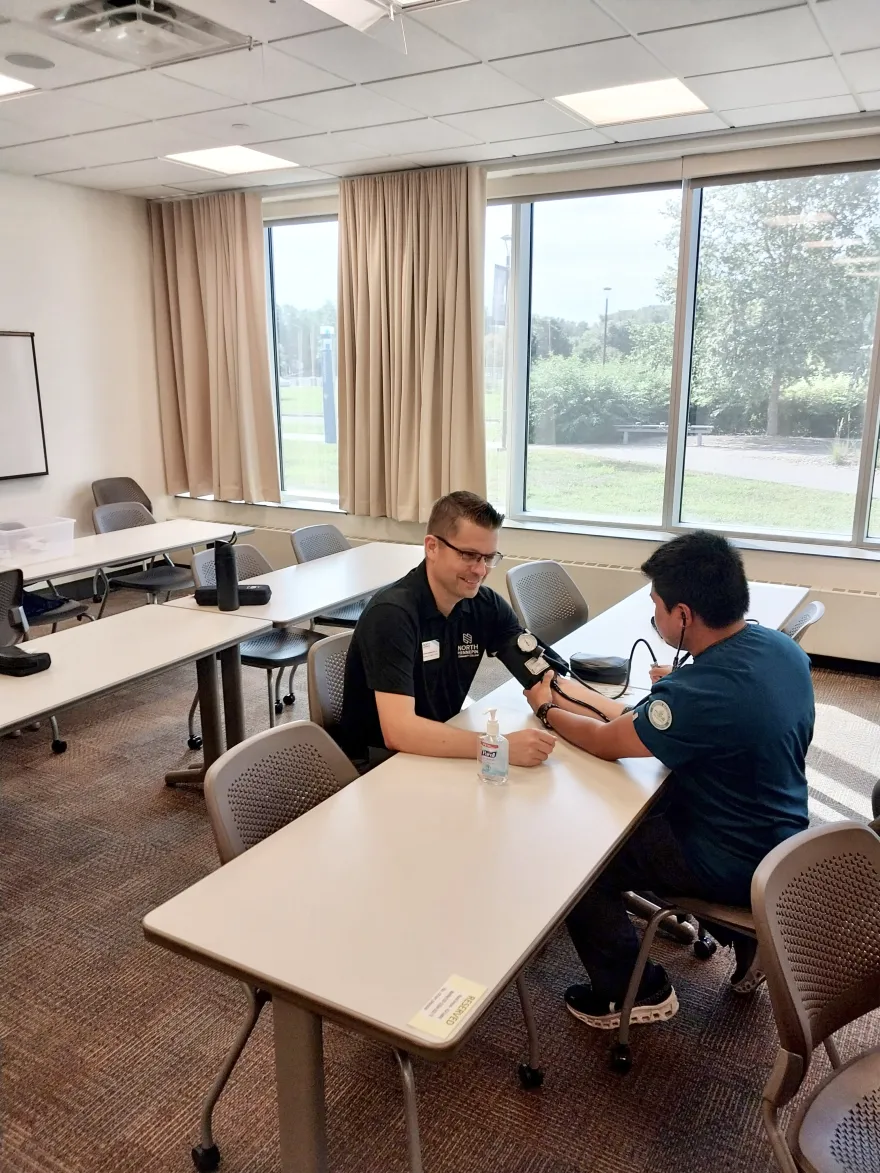  a photo of Derrick getting his blood pressure taken