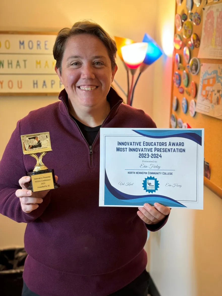 NHCC staff, Erin Farley smiling with her award and certificate.