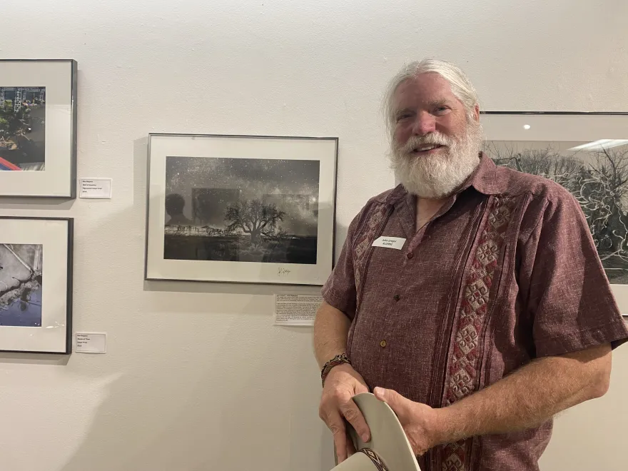 a photo of a former nhcc artist and his photo in the gallery