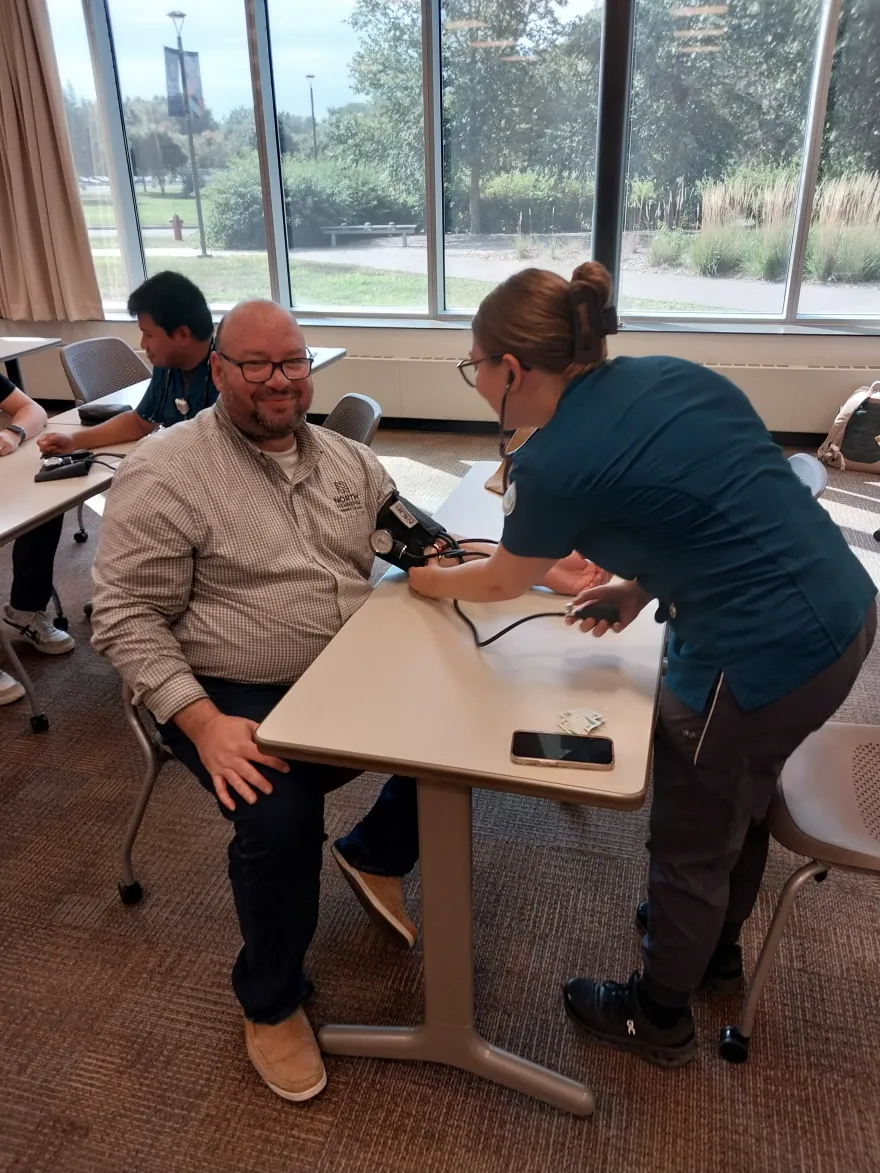 a photo of Rolando getting his blood pressure checked