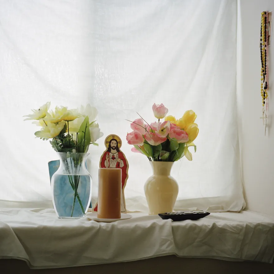 a photo of two bouquets in vases on a window sill at a Karen alter