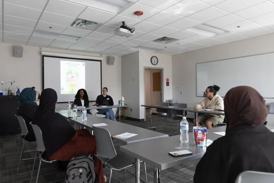 a photo of students in the Campus Center having a discussion together in partnership with CARE Center staff. 