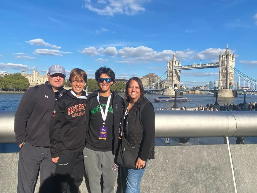 a photo of Melissa and her three members at the Tower Bridge in London, England. 