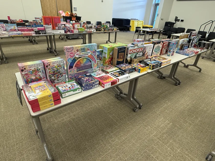 a photo of assorted children's toys on tables in NHCC's Helling Hall for the 2024 Toy Express event. 