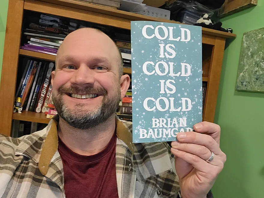 a photo of NHCC faculty, Brian Baumgart with his recently published chap-book. 