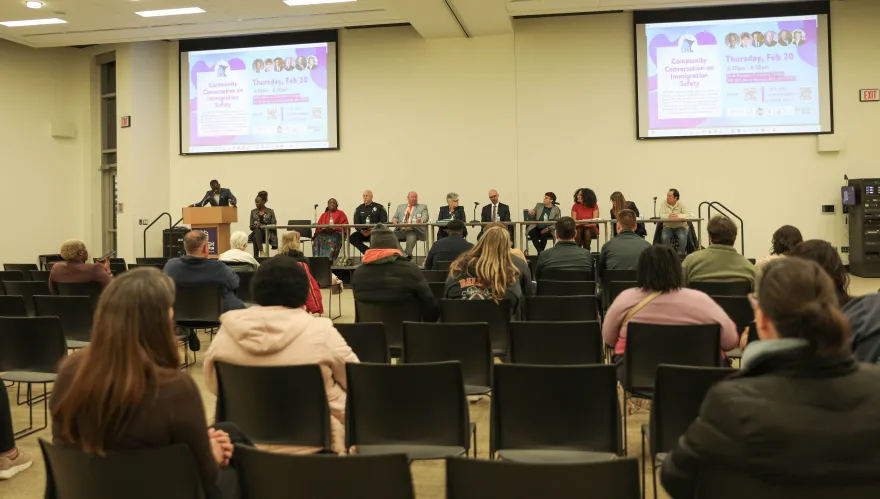 a photo of a panel of guest speakers in Helling Hall at NHCC for an immigration safety event. 